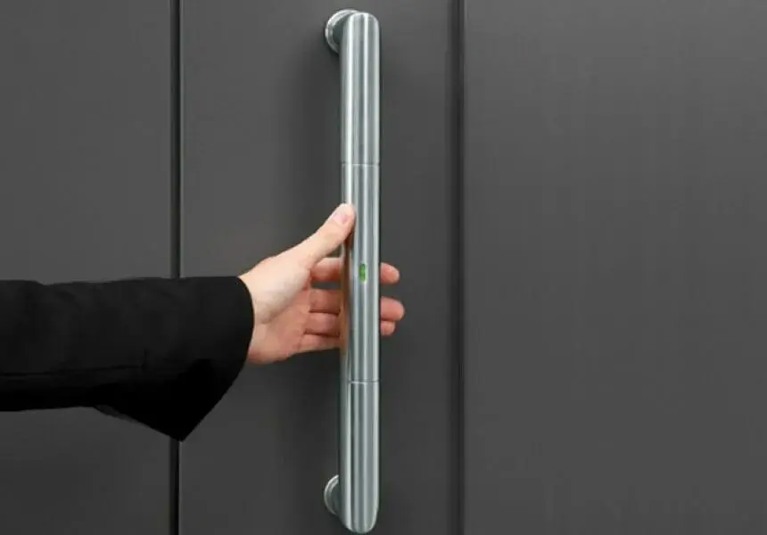 A hand carefully polishing a piece of metal hardware.