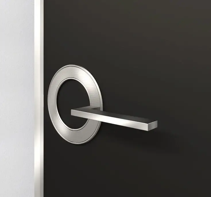 A sleek, minimalist chrome handle on a modern grey door.