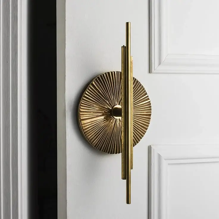 A geometric, polished gold handle reflecting Art Deco style.