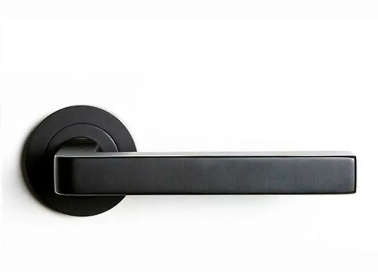 A hand appreciating the texture of a door handle.