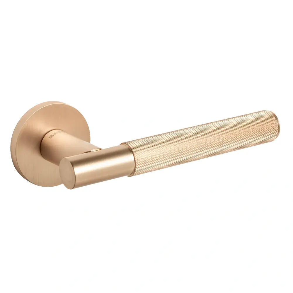 The subtle patina forming on a brass surface.