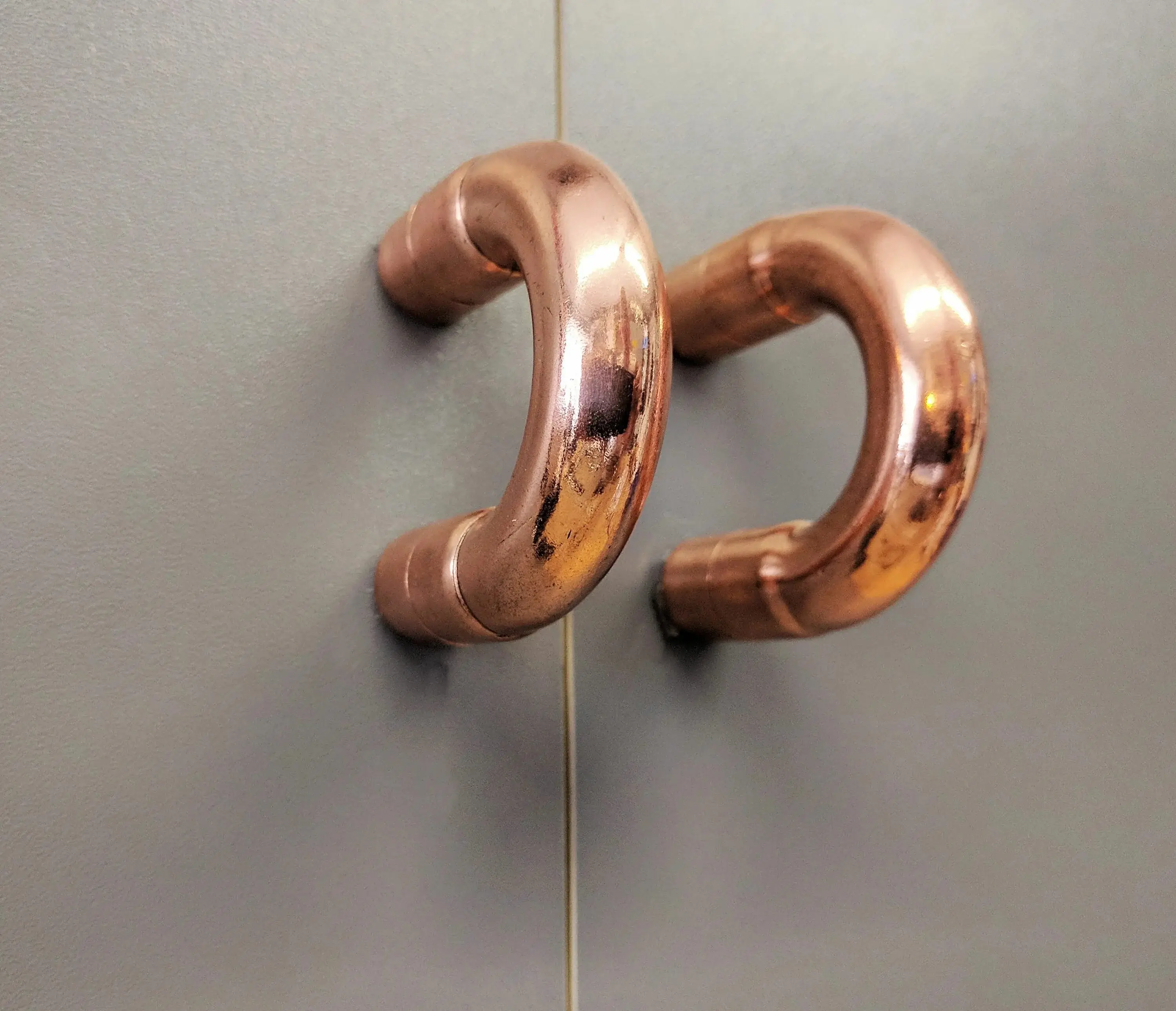 Close-up of a hand polishing a metal object.